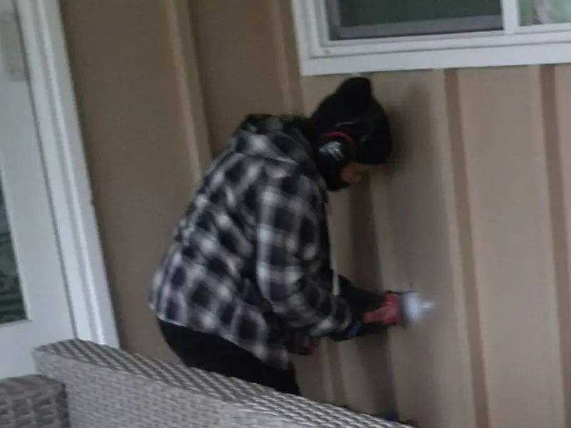 Professional electrician installing an exterior outlet in East Hampton
